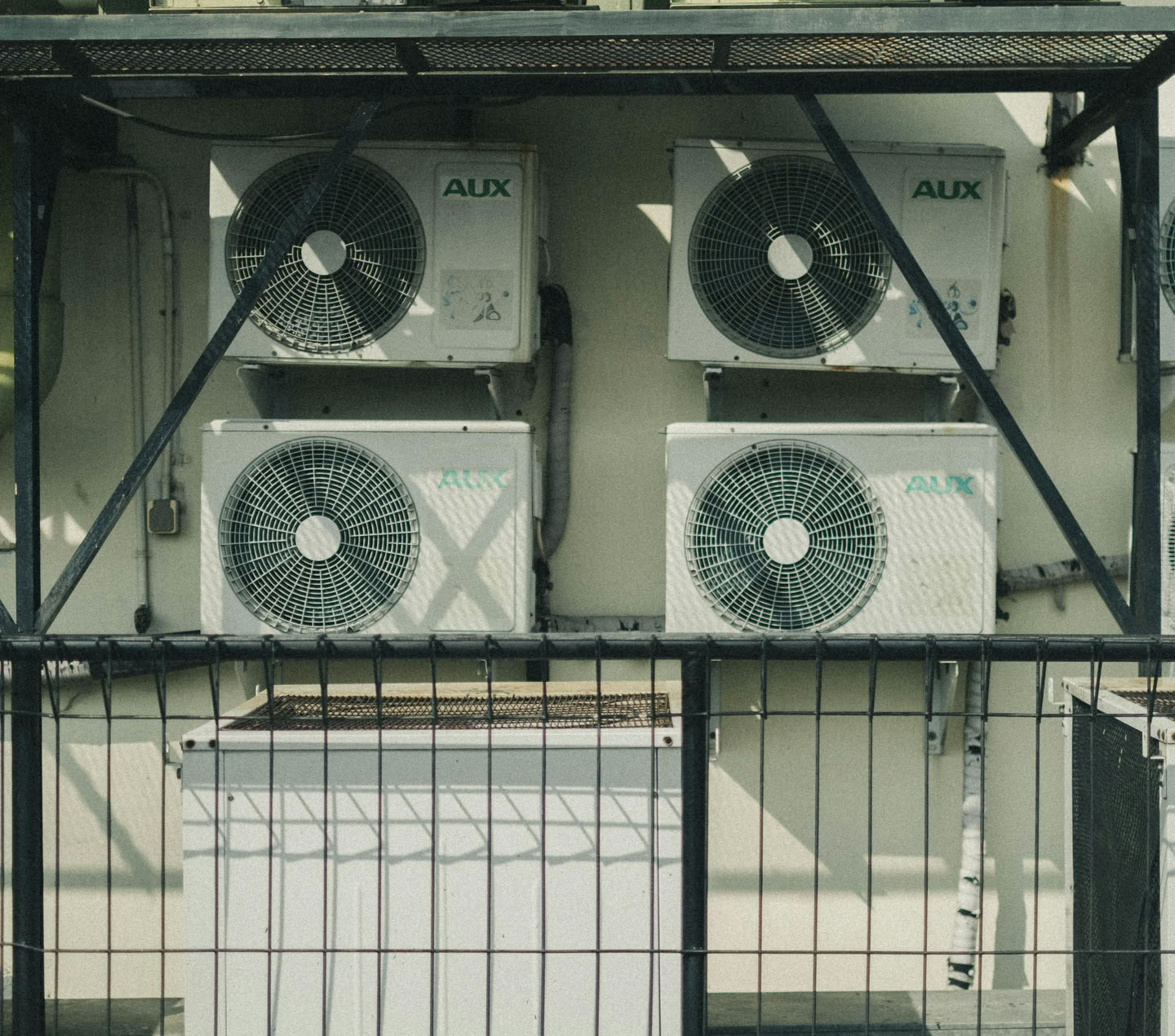 Vertical shot of multiple air conditioner units outside a building